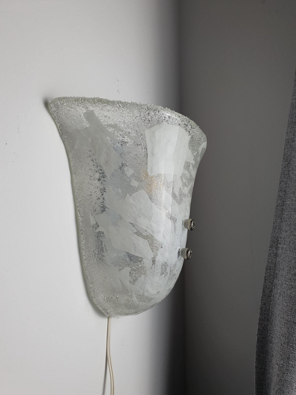Murano glass shell wall sconce side profile, showing satin glass-sand reverse texture and white metal backplate