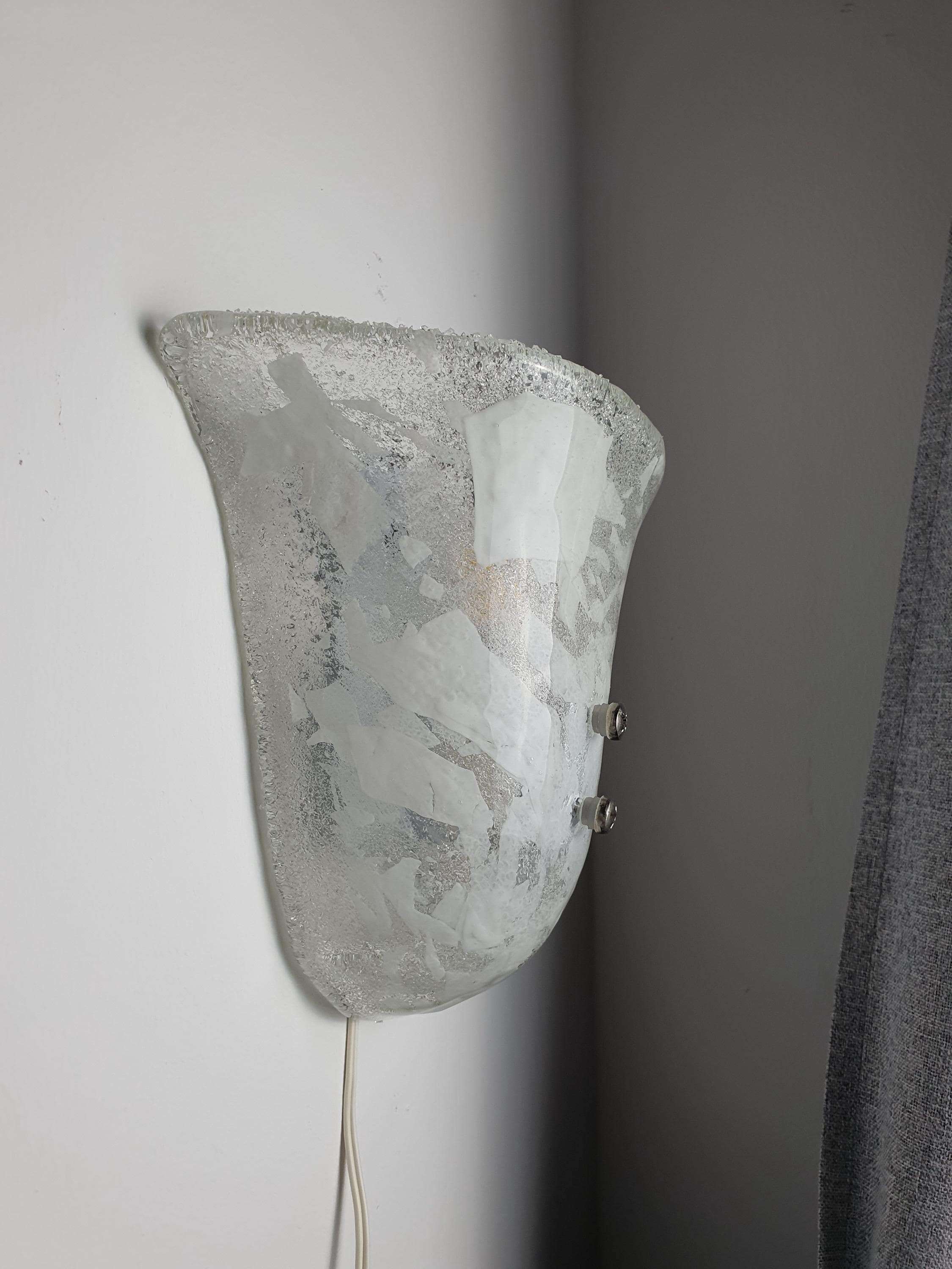 Murano glass shell wall sconce side profile, showing satin glass-sand reverse texture and white metal backplate