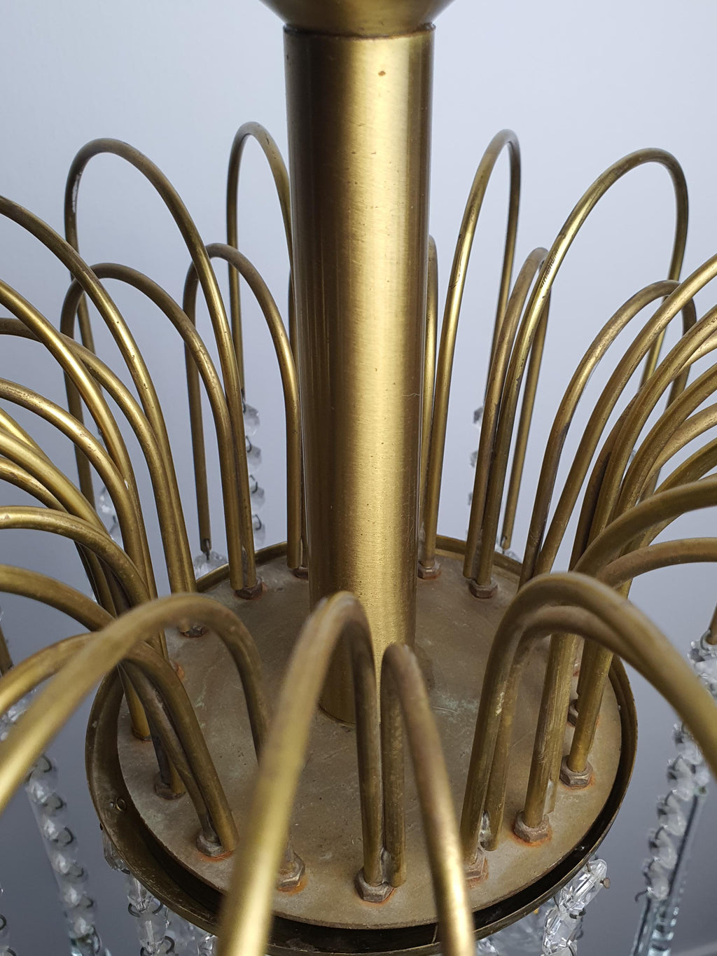 Murano glass chandelier — clear teardrop elements catching and refracting light, detail