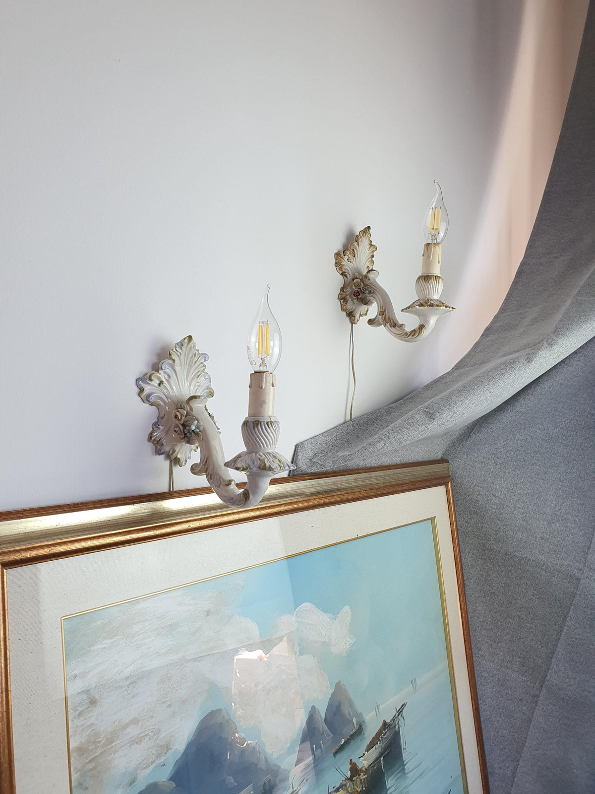 Different decorative colours on a pair of vintage Italian floral wall lights
