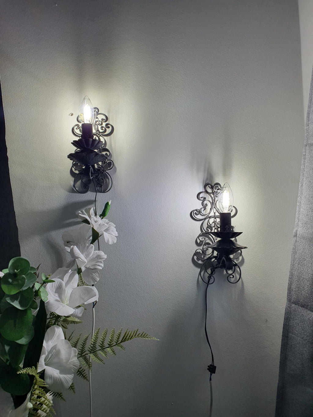 Vintage wrought iron wall light — patina and wear consistent with handcrafted vintage nature