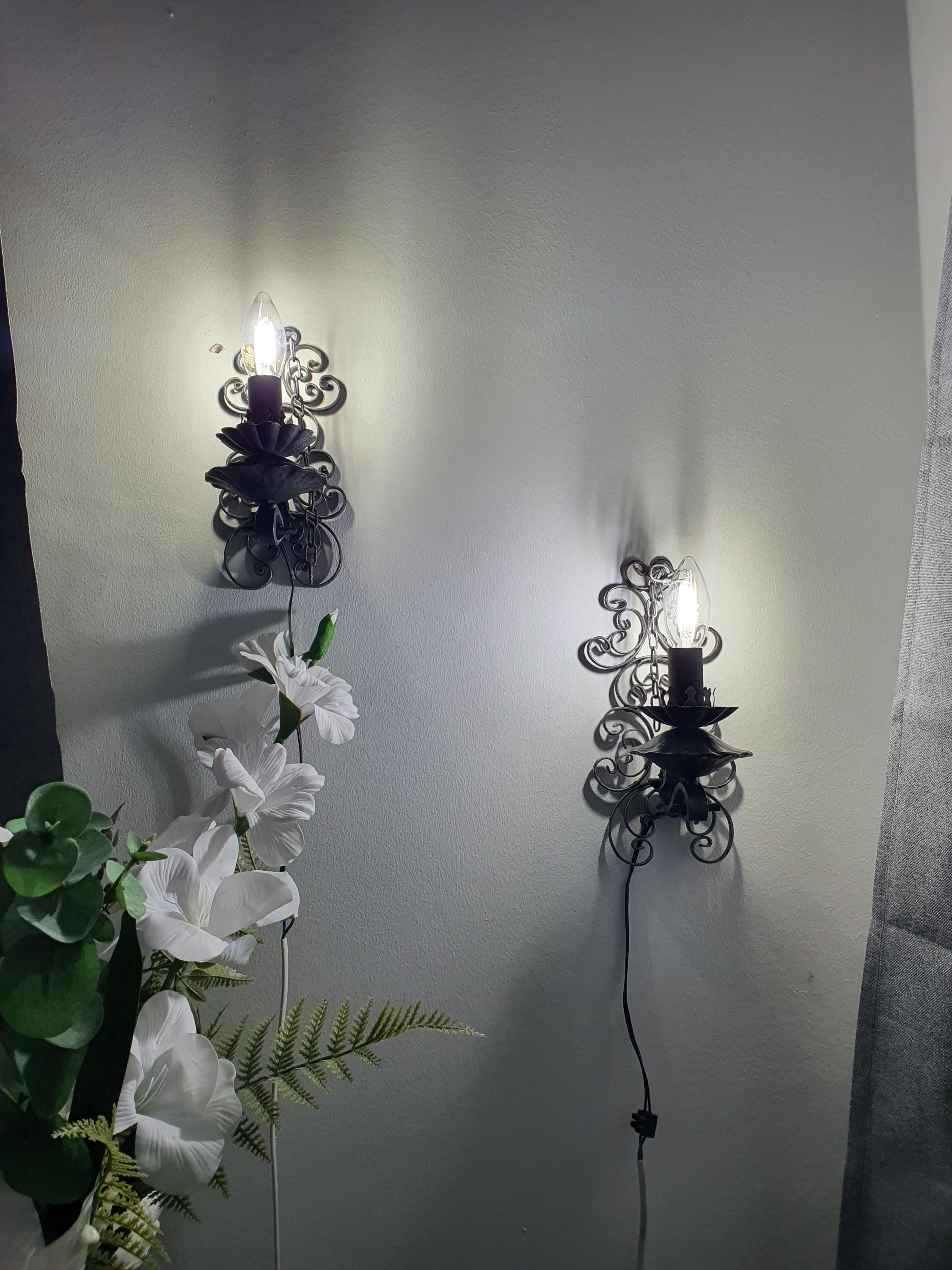 Vintage wrought iron wall light — patina and wear consistent with handcrafted vintage nature