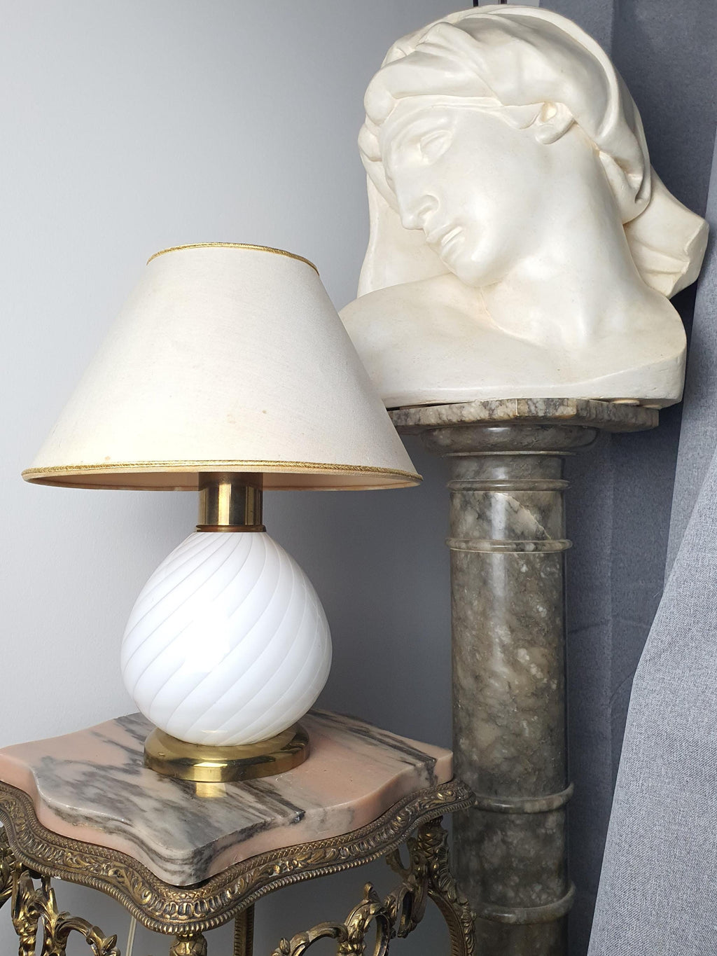 Vintage Murano white candy swirl bedside lamp front view, flowing white swirl glass base, brass base, beige textile shade