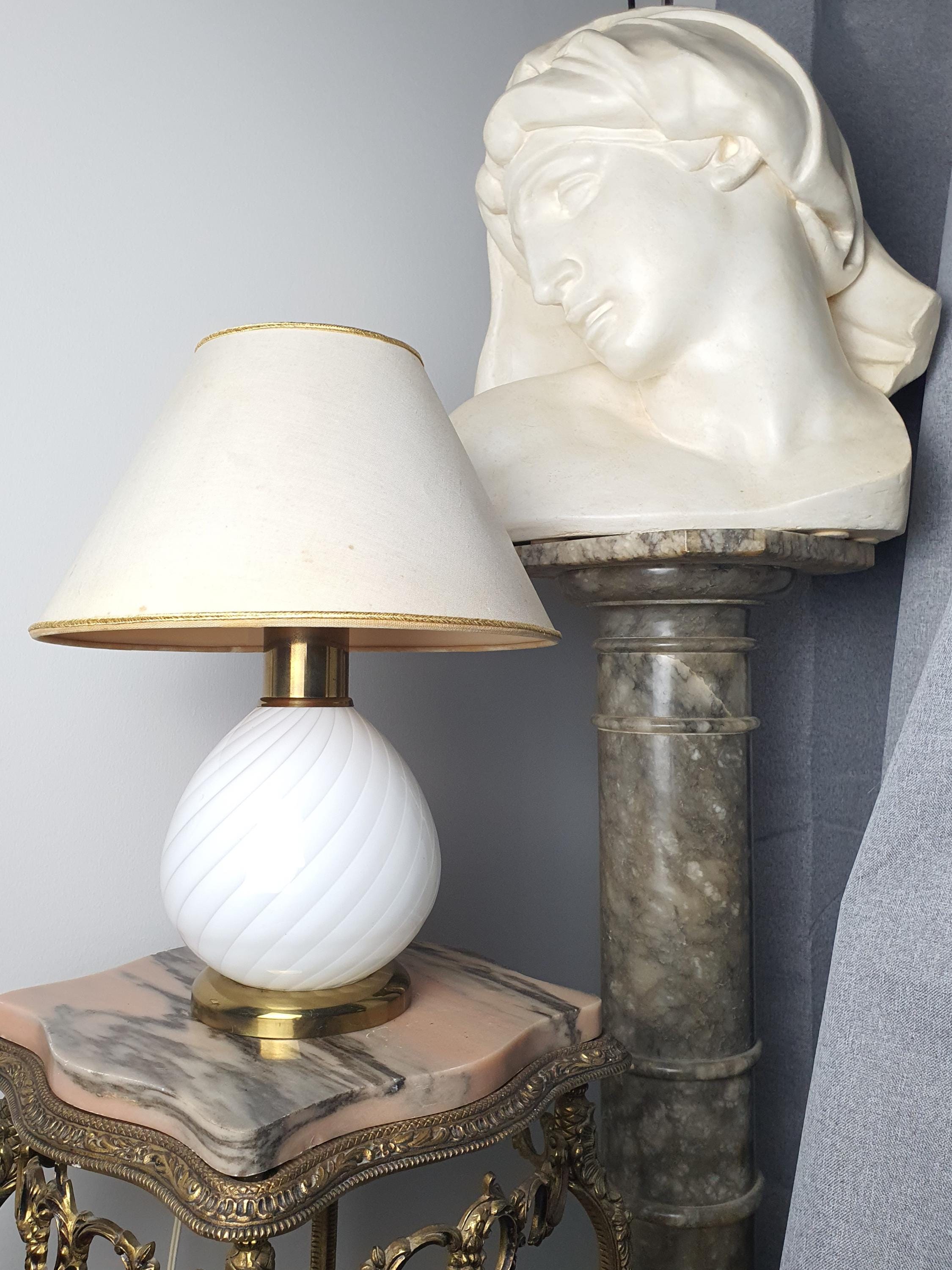 Vintage Murano white candy swirl bedside lamp front view, flowing white swirl glass base, brass base, beige textile shade