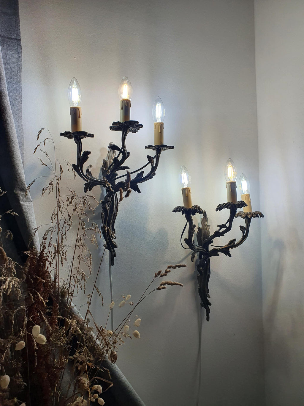 Pair of Gothic 3-arm wall sconces — both fixtures shown together, hallway setting