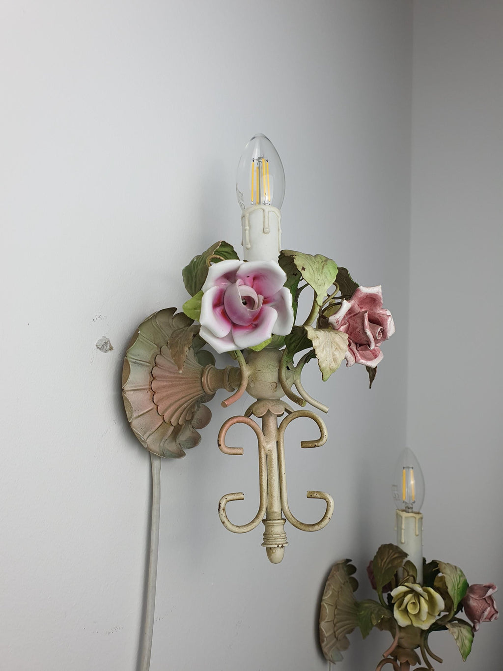 1950s Italian tole sconce pair — romantic floral design, side view