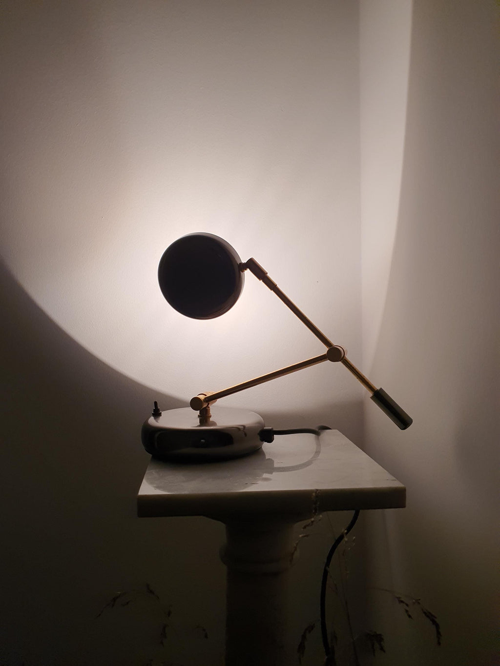 Mid-Century Modern Italian swing arm desk lamp with gold-toned articulated arm, brown metal base, and chrome accents
