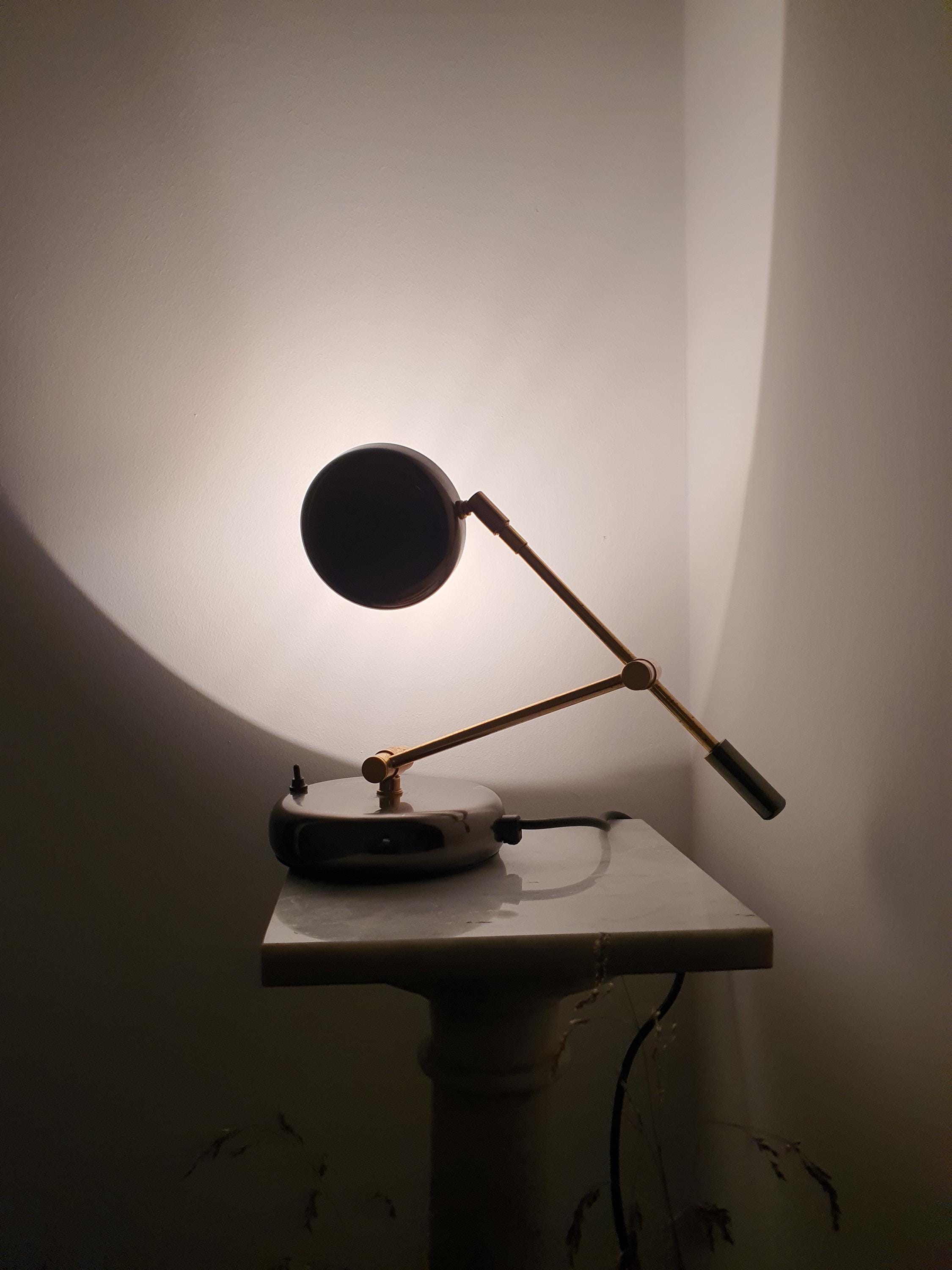 Mid-Century Modern Italian swing arm desk lamp with gold-toned articulated arm, brown metal base, and chrome accents