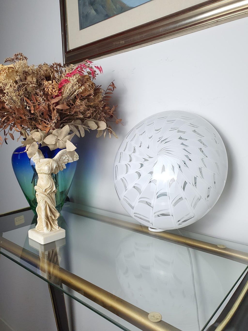 Vintage Murano starburst flush mount lit, intricate white spiderweb pattern glowing, soft ambient light, MCM interior