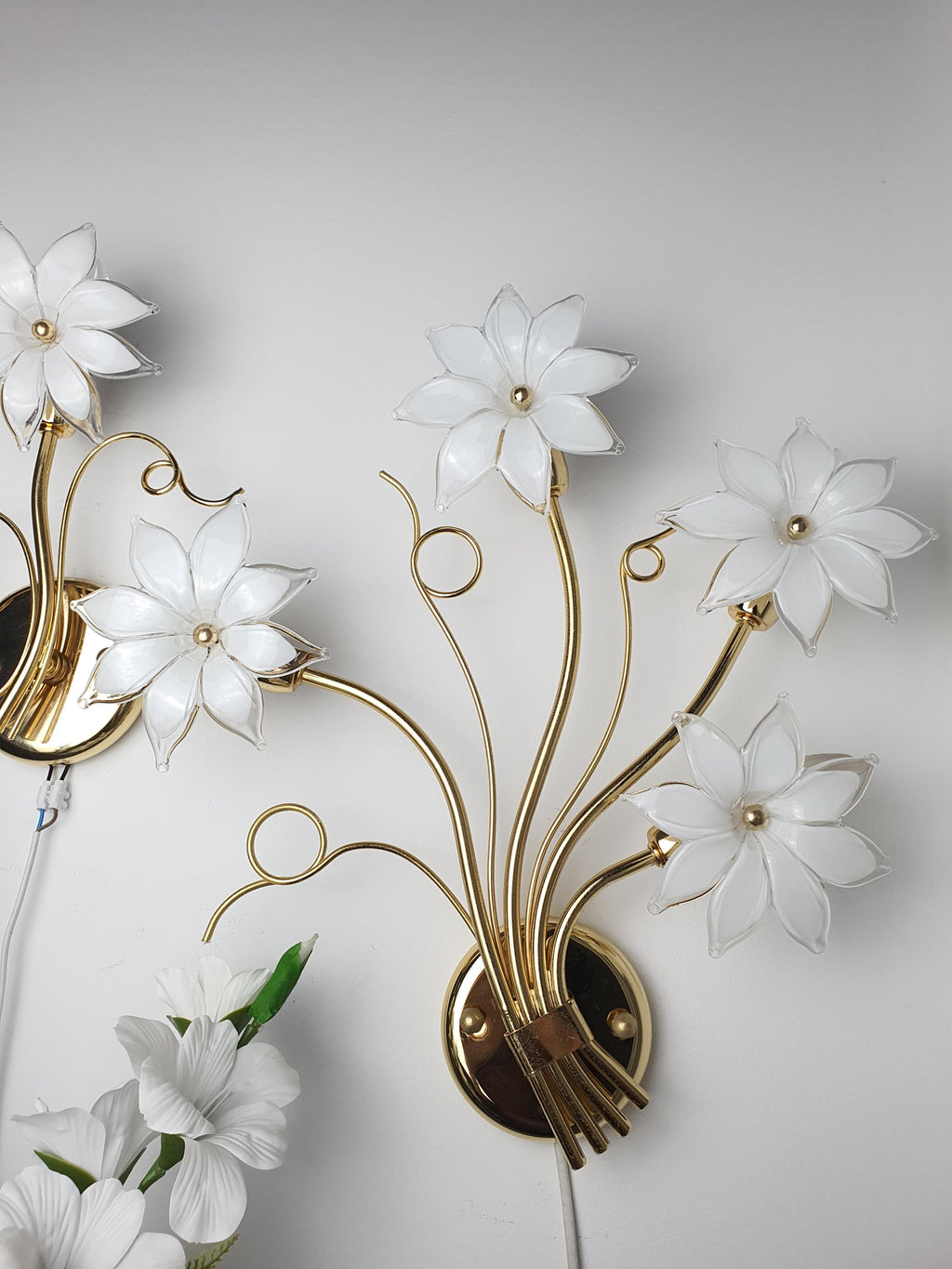 Asymmetrical pair of vintage Italian Murano glass floral sconces in bedroom, white blooms soft glow, Hollywood Regency romantic