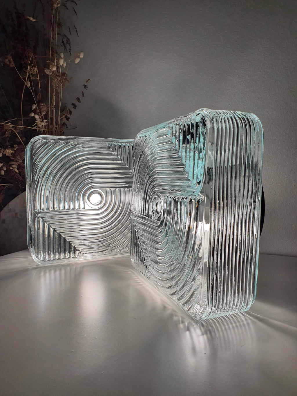 Pair of vintage square Brutalist MCM wall sconces in hallway, stamped clear glass, mixed metal bases, modernist loft interior