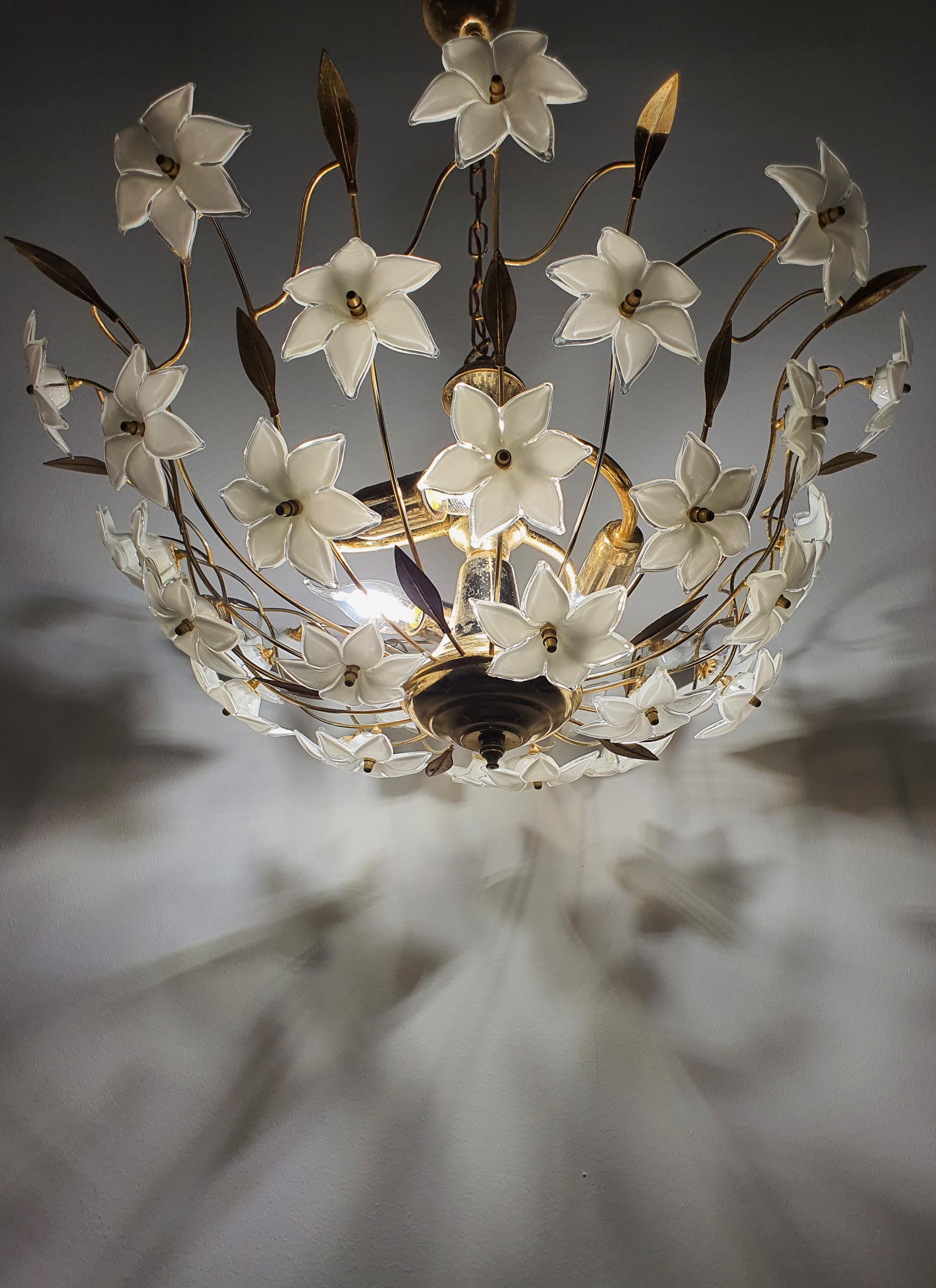Vintage 1980s Murano glass floral chandelier lit, soft white flower glow, gold-tone bowl, Hollywood Regency dining room