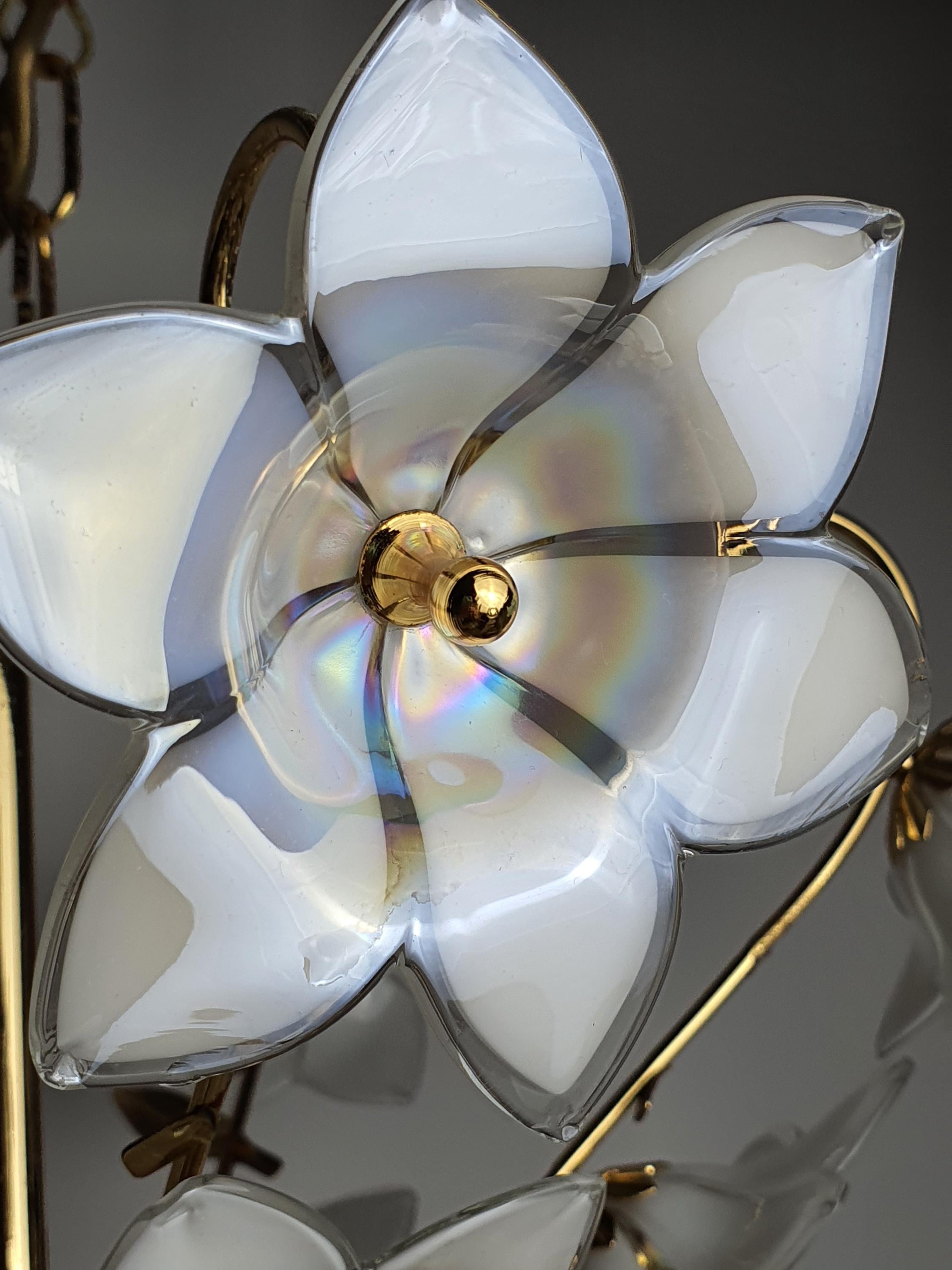 Close-up of iridescent white Murano glass flower with petrol pink violet reflections, floral bouquet chandelier