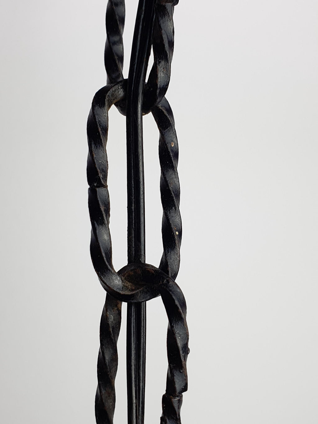 Mazzega style Murano pendant in wine cellar, moody amber glow, black iron frame, rustic Italian architectural lighting