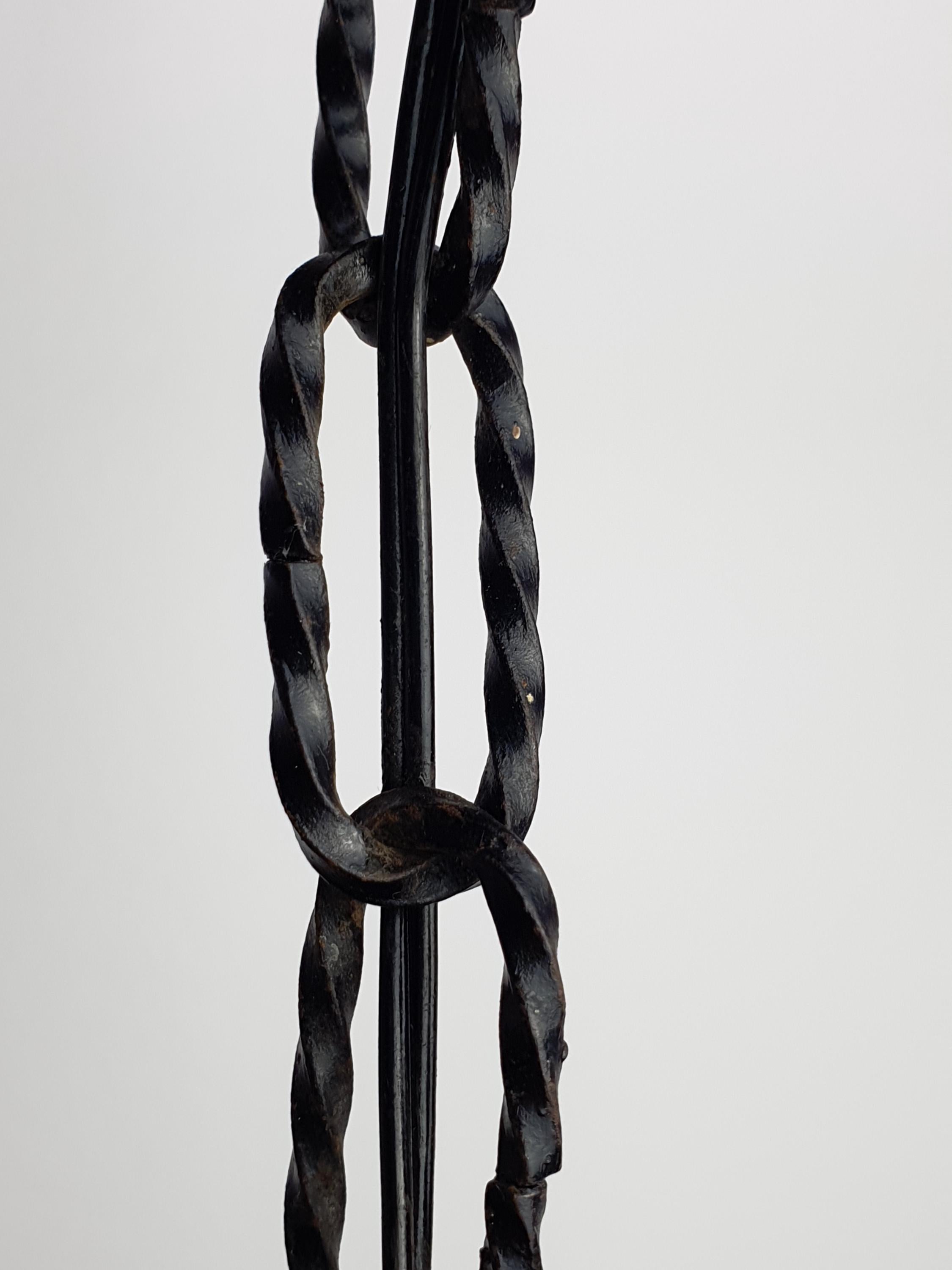 Mazzega style Murano pendant in wine cellar, moody amber glow, black iron frame, rustic Italian architectural lighting