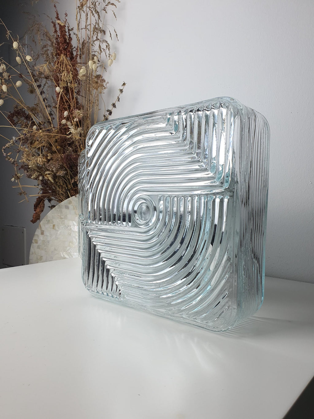 Stamped clear glass and metal base contrast on vintage square Brutalist MCM wall sconce pair, 1960s–1980s Italy


