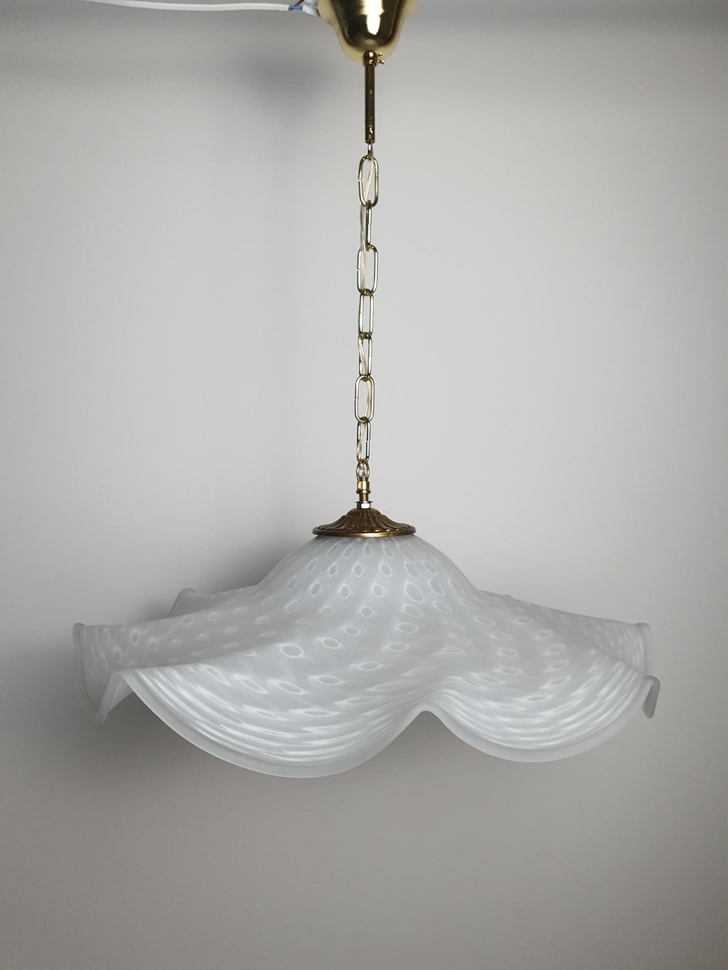 Murano glass pendant light — installed over dining area, ambient warm lighting