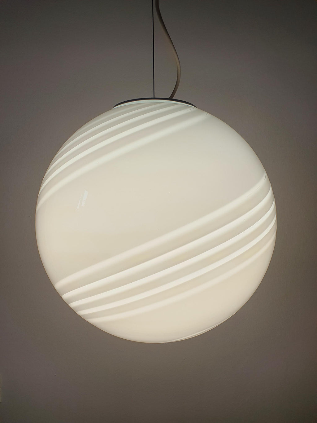 Vintage Murano large white swirl globe pendant above dining table, 38cm sphere, warm diffused glow, Scandinavian interior