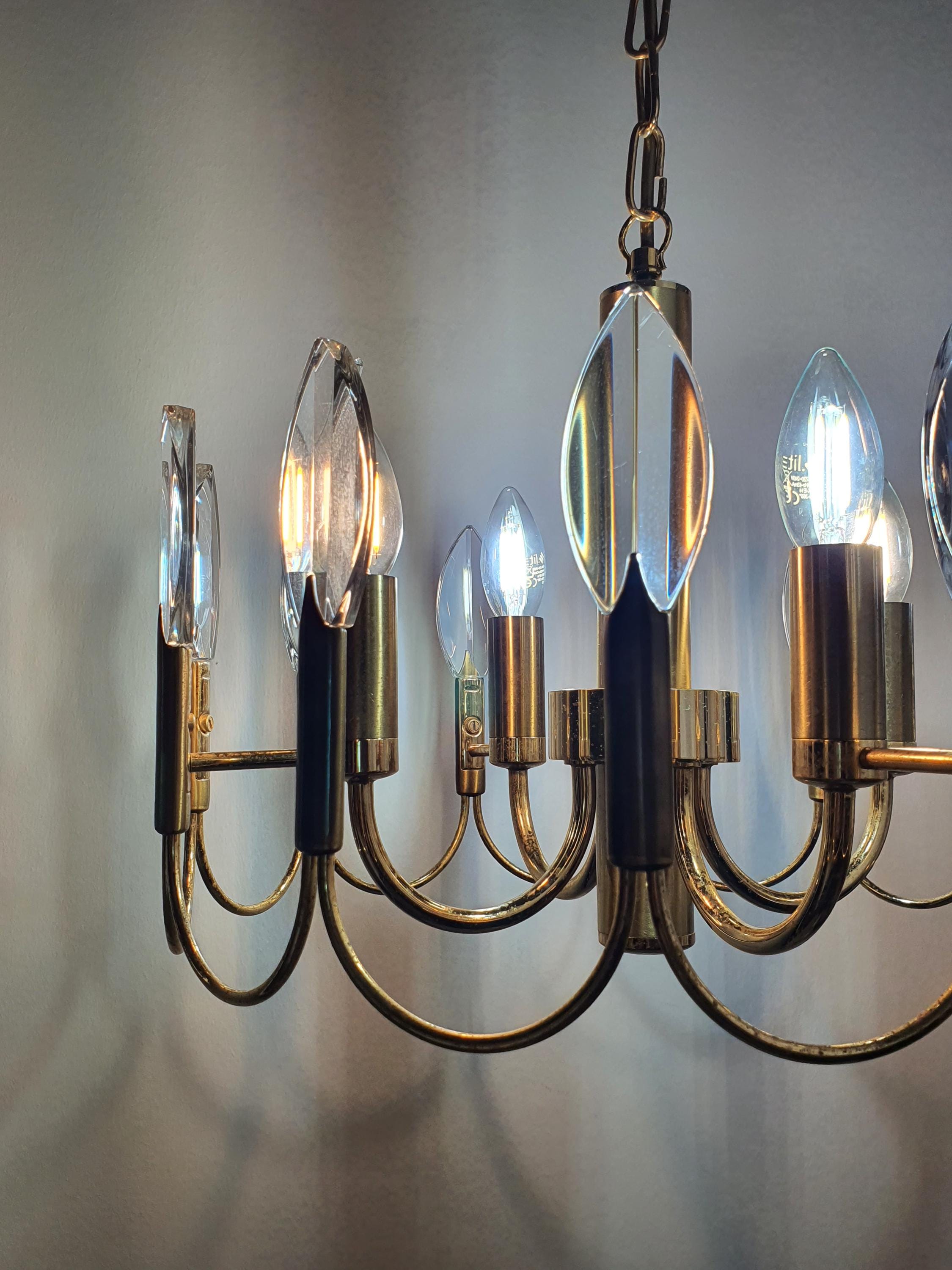 Vintage Sciolari-attributed 4-arm brass chandelier unlit, showing double-wave arm silhouette and crystal drops