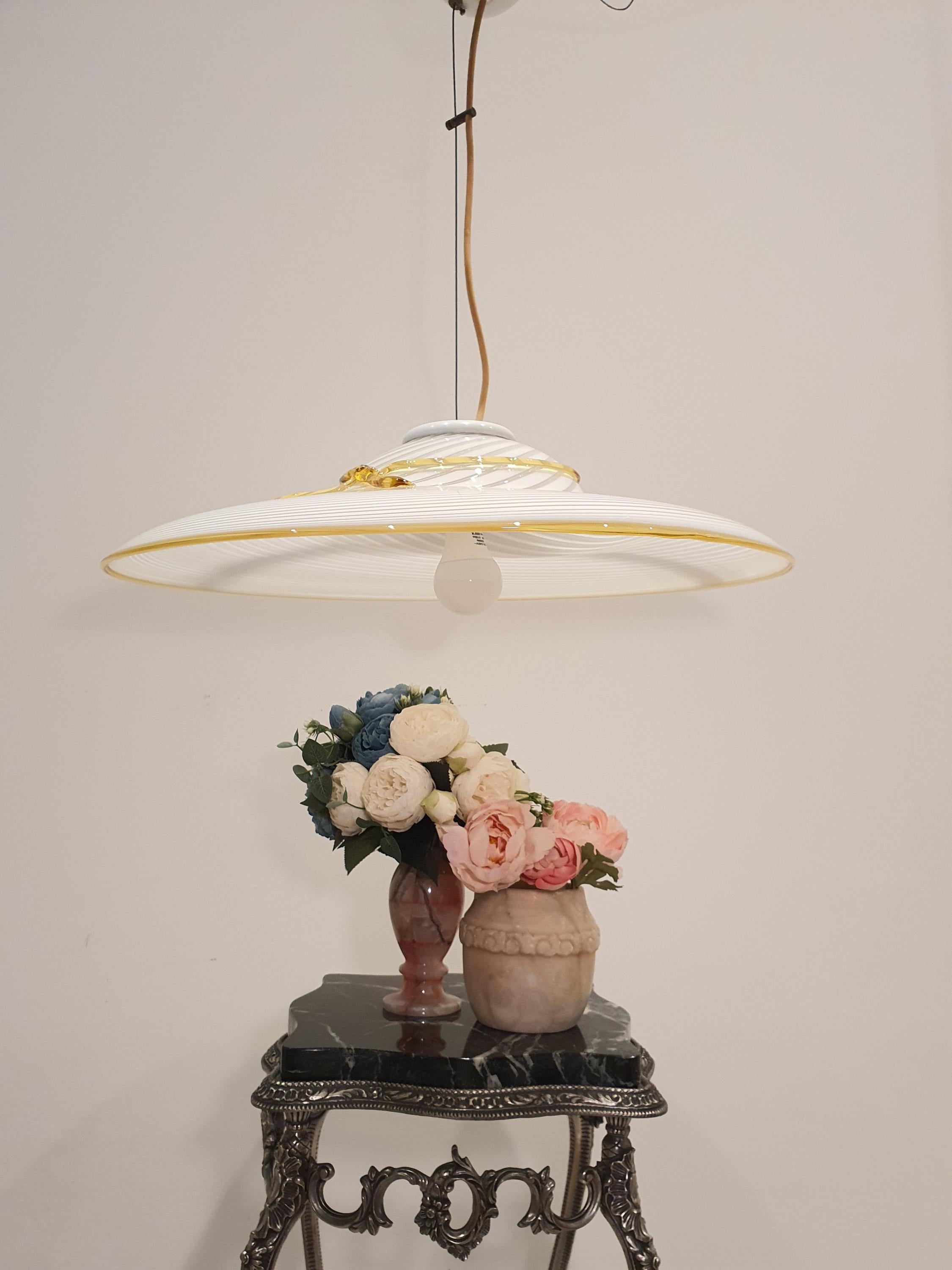 Vintage Murano glass pendant — illuminated, warm soft glow through white swirl glass