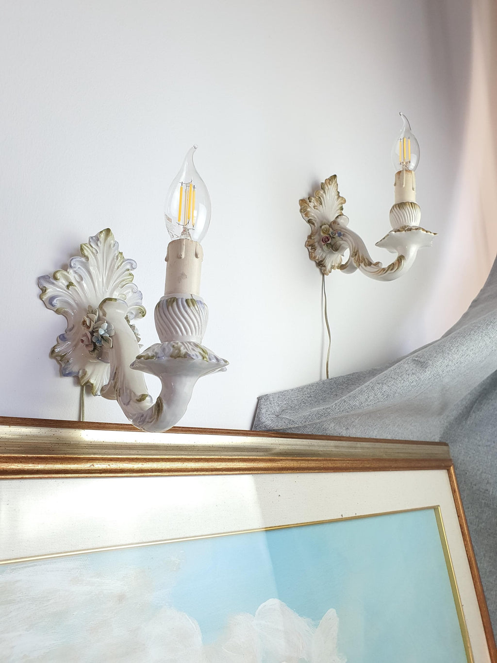 White candle-style ceramic wall light with blue, pink and yellow roses
