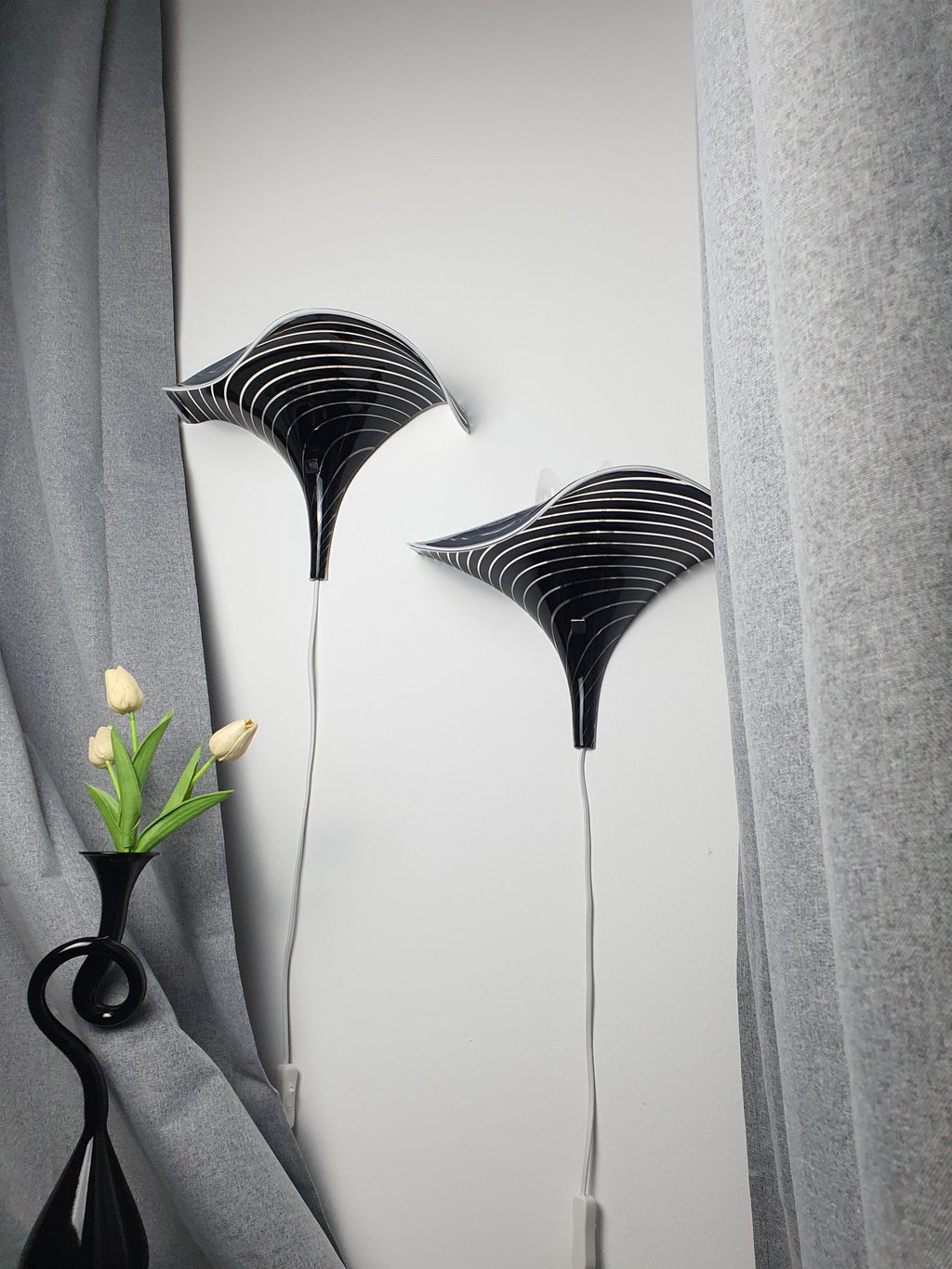 Vintage Murano calla lily wall sconce front view, black and clear zebra stripe layered glass, organic wave silhouette, floral form