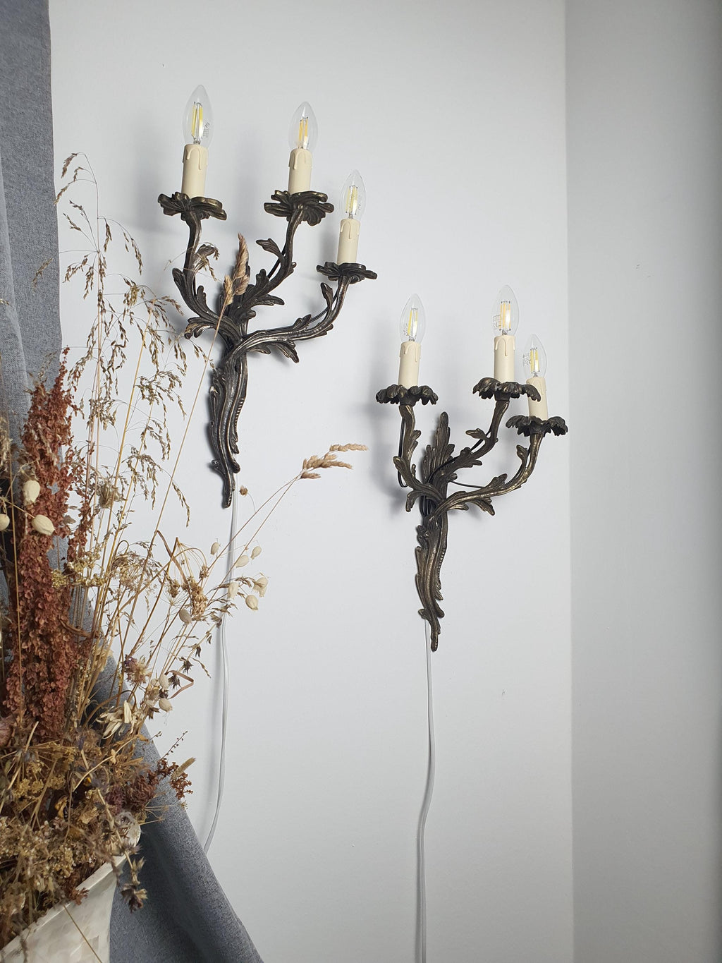 Medieval-style handcrafted wall sconce — dark grey metal patina and wear, side profile