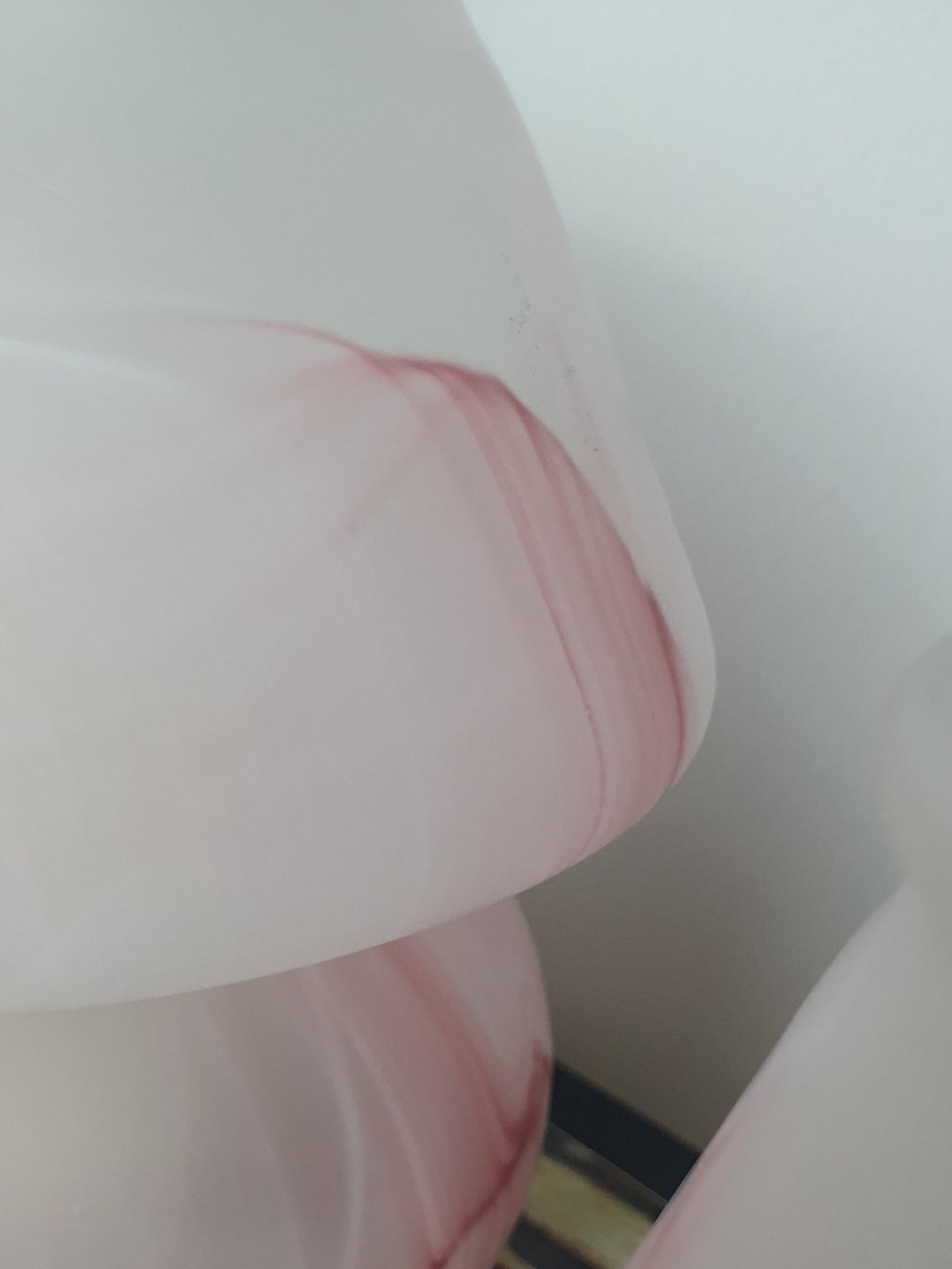 Detail of marbling in a vintage pink Murano glass lamp
