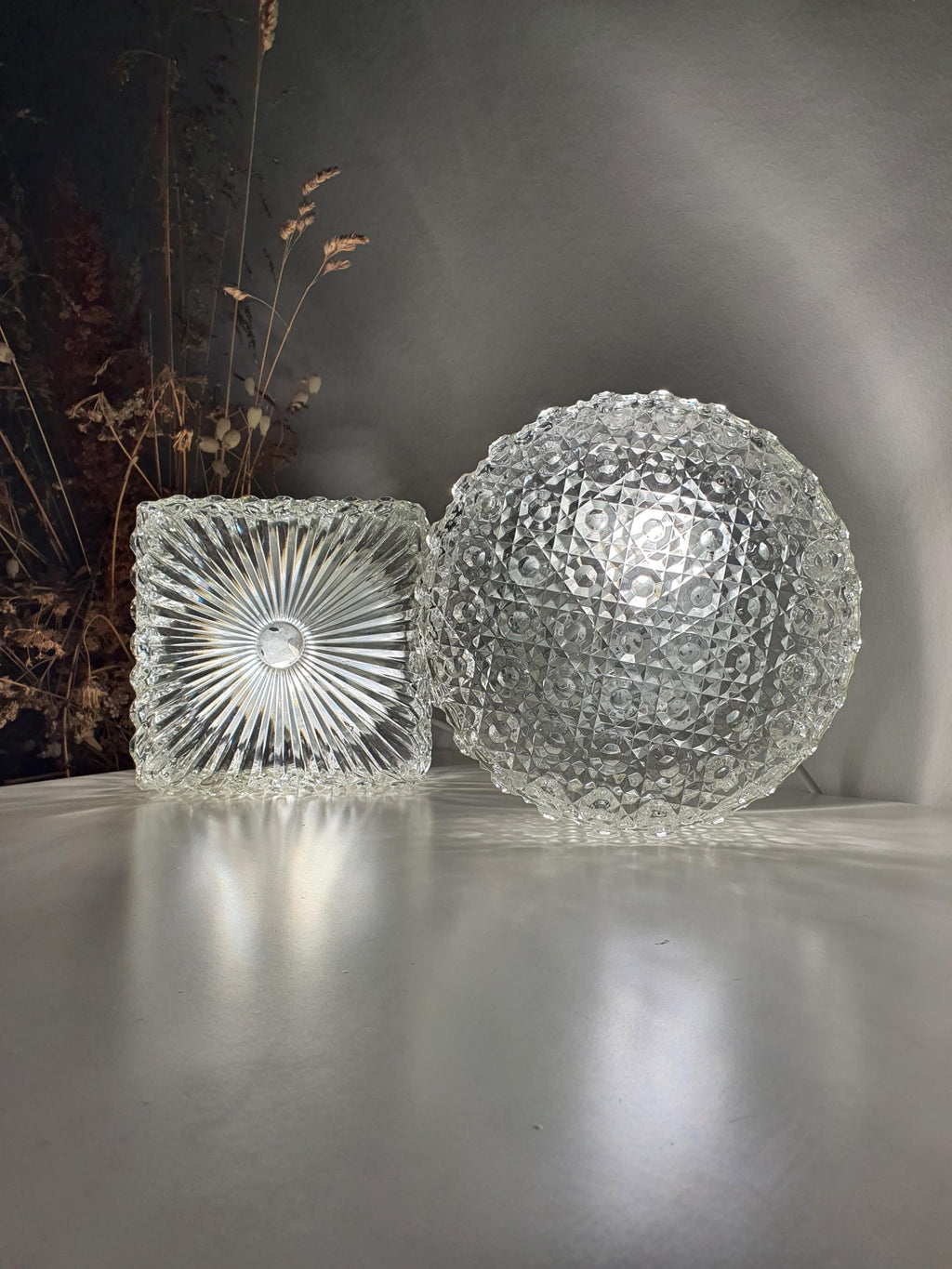 Sculptural clear glass surface on a Brutalist-style wall light
