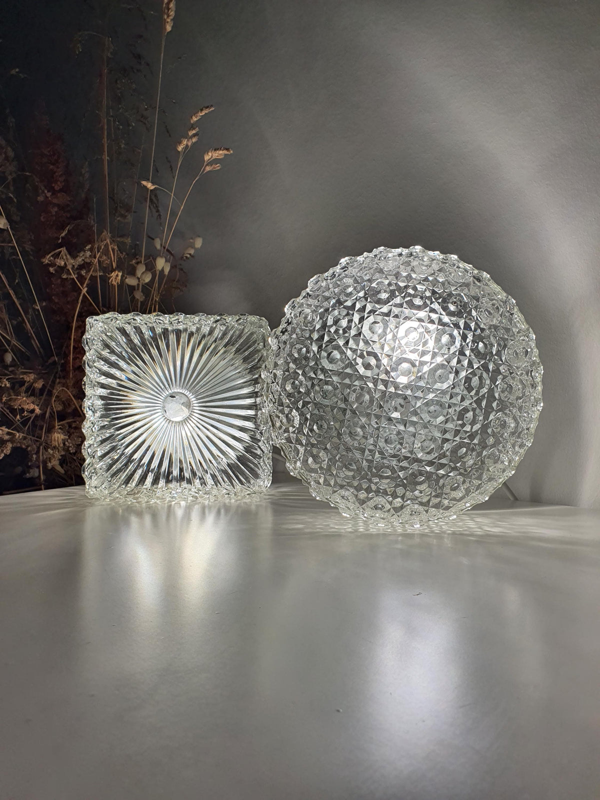 Sculptural clear glass surface on a Brutalist-style wall light
