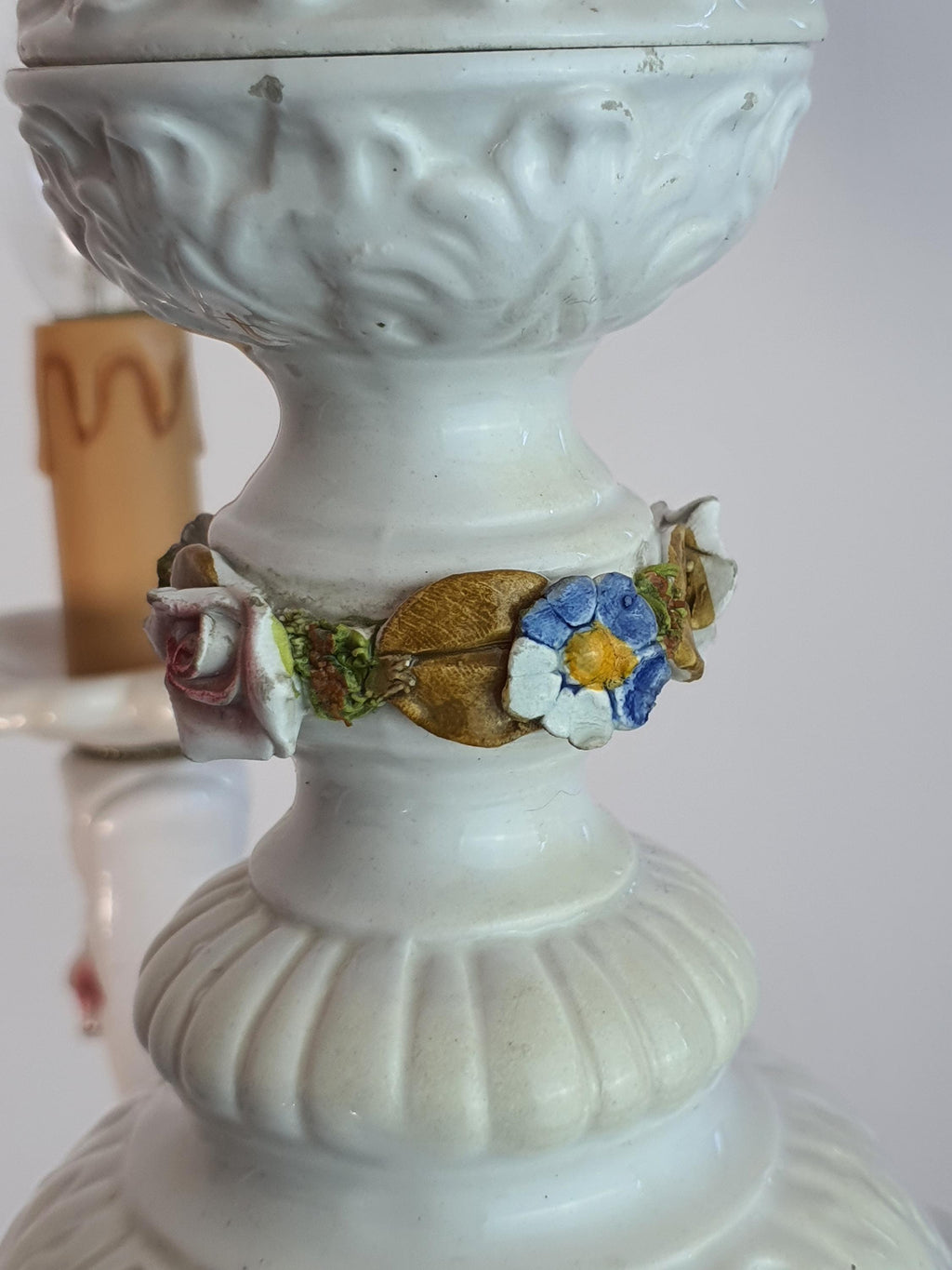 Blue porcelain flowers decorating a white ceramic chandelier
