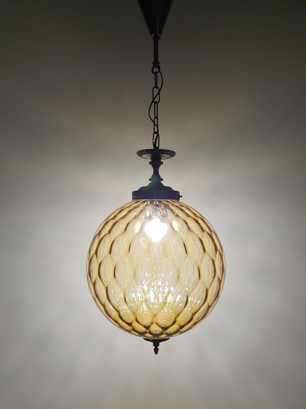 Detail of brass fitting patina and oxidation, vintage Murano honeycomb globe pendant