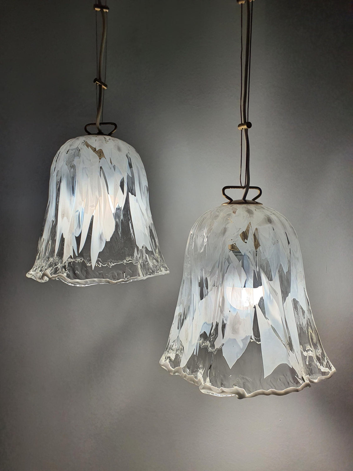 Differing bulb-holder assemblies on a pair of vintage La Murrina pendant lights
