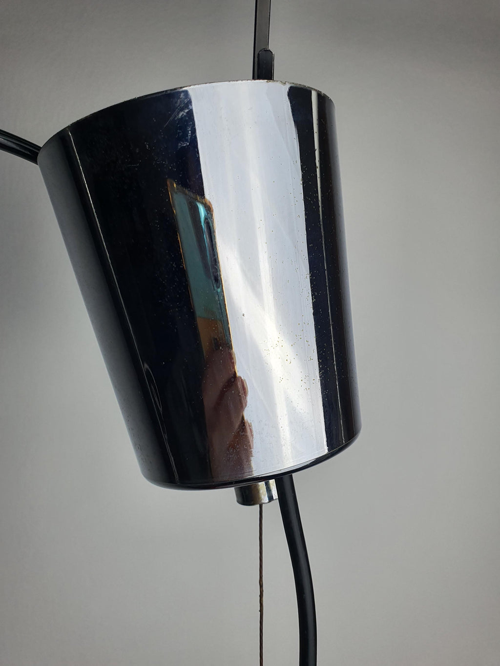 Italian retro pendant light — chrome interior reflection and orange accent, close-up