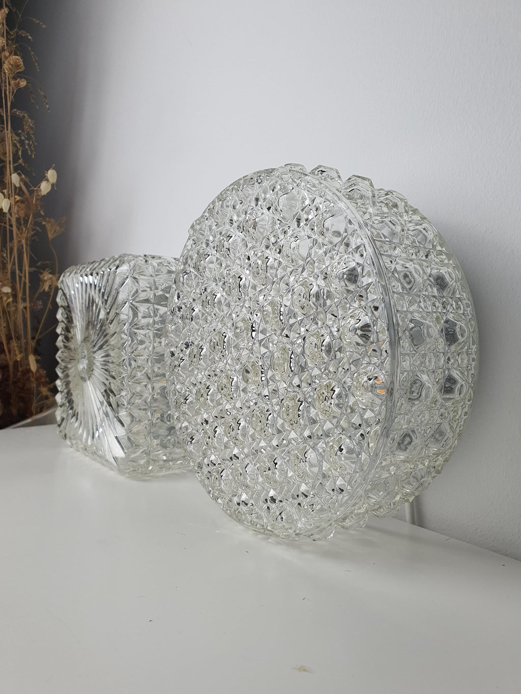 Circular glass shade with bold raised texture and geometric form
