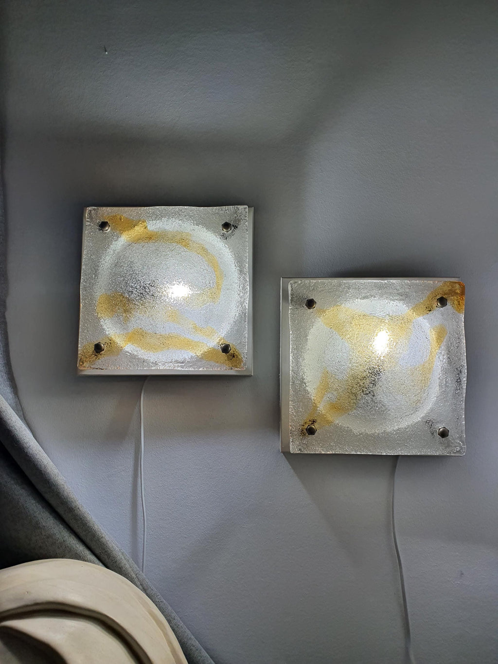 Pair of vintage Mazzega Murano amber iced square lights lit, warm amber glow through ghiacciato iced glass, Brutalist MCM interior