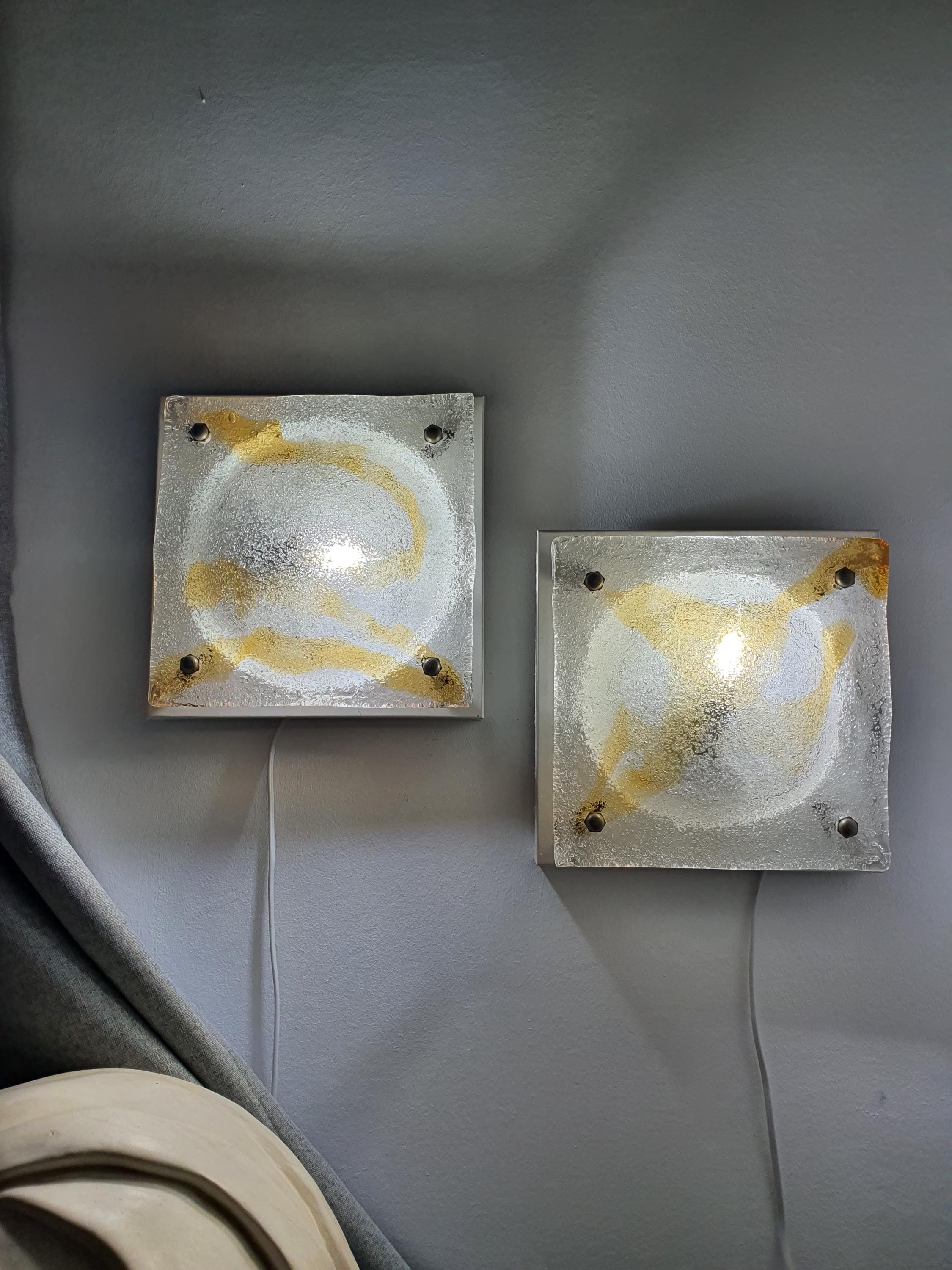 Pair of vintage Mazzega Murano amber iced square lights lit, warm amber glow through ghiacciato iced glass, Brutalist MCM interior