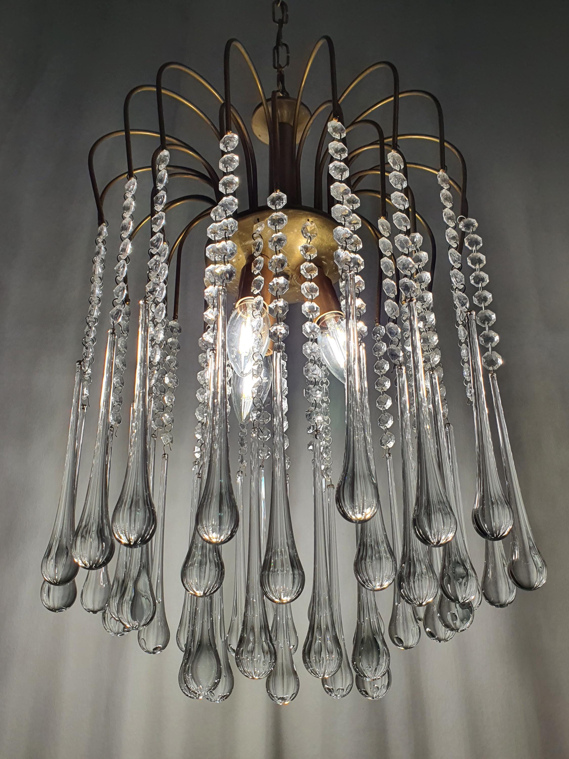 Vintage Murano glass chandelier — illuminated, delicate cascade shimmer filling the room