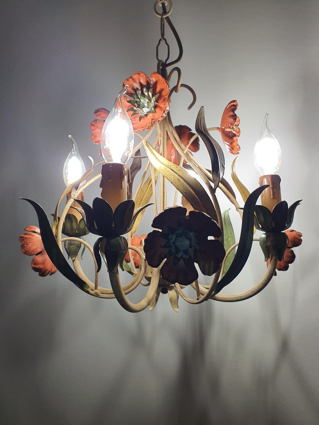 Vintage Italian tole chandelier in bedroom, warm candle glow, red poppy botanical painted tole, romantic cottage farmhouse