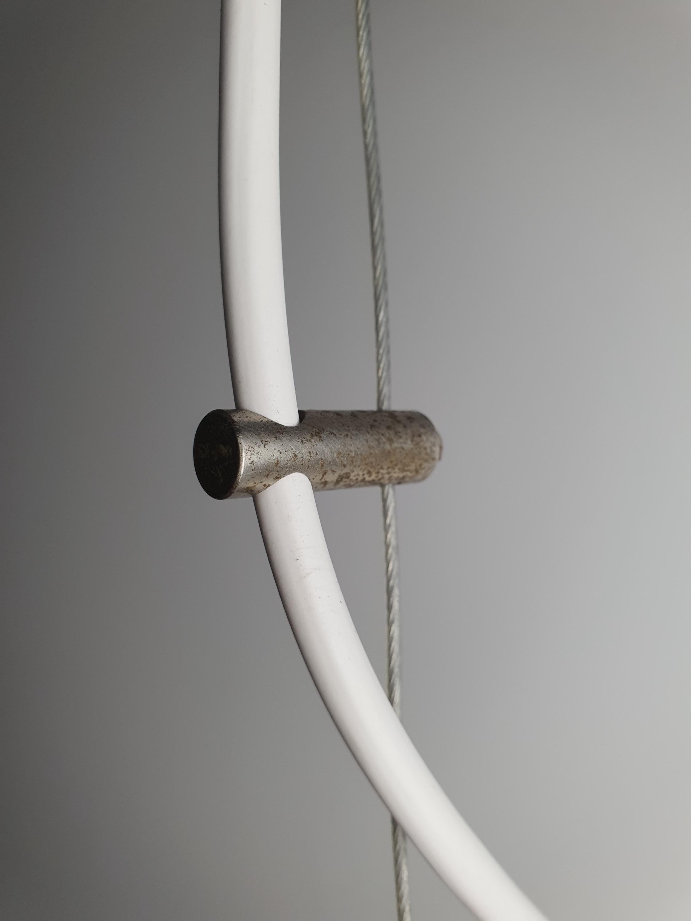 Close-up of brass canopy and fittings on vintage Murano white swirl egg pendant, warm aged brass patina detail