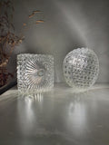 Set of two vintage clear glass wall sconces, one round and one square
