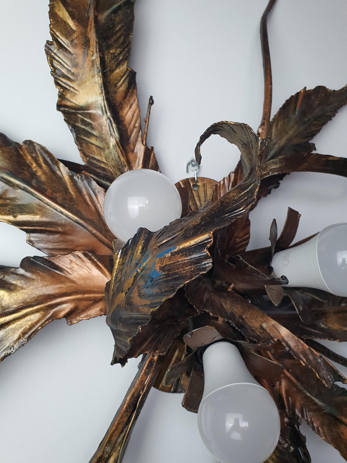 Layered metal foliage on an XXL vintage wall or ceiling light

