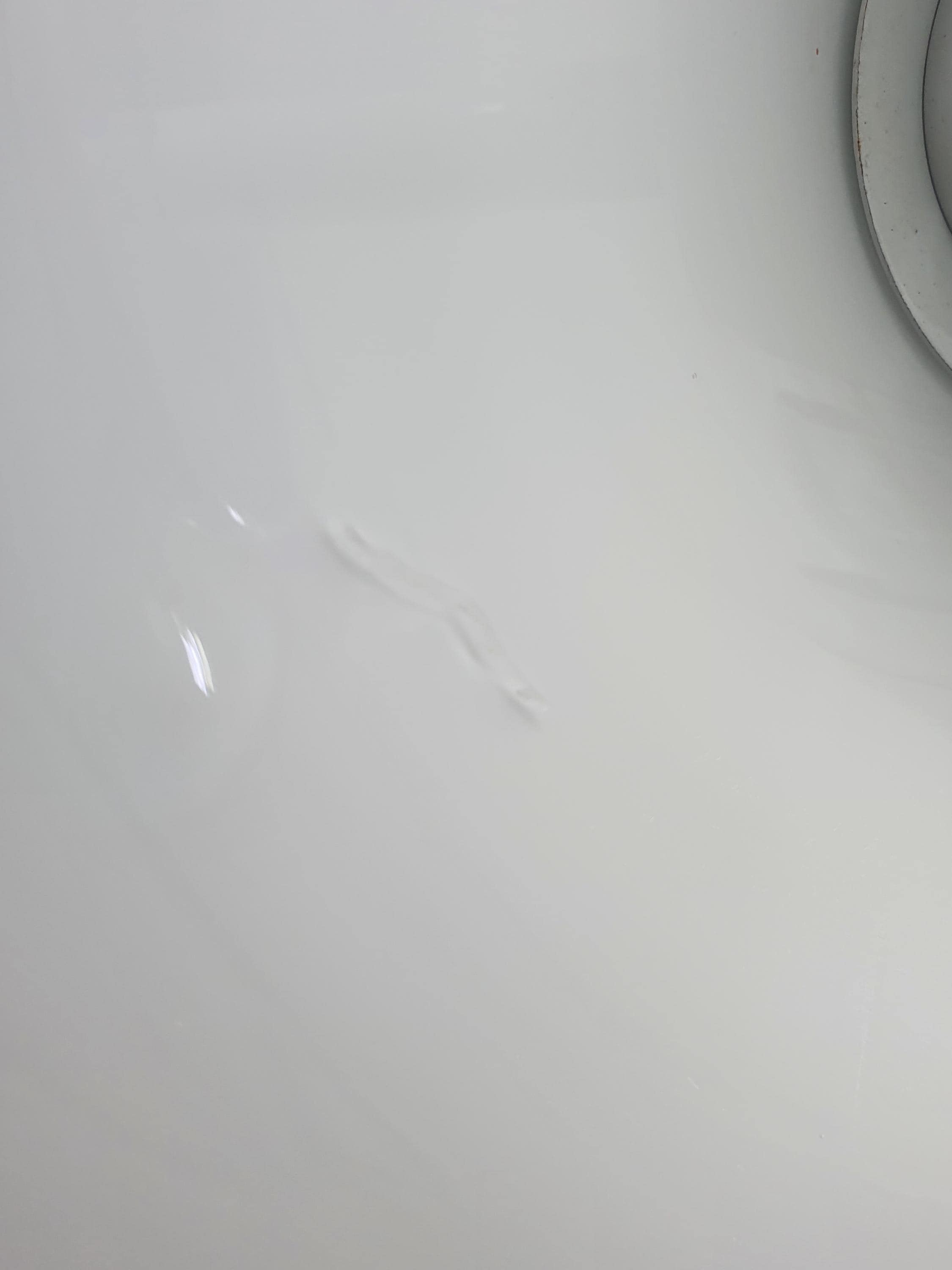 Close-up detail of the white glass lamp shade surface, showing faint scratches consistent with vintage age and use.
