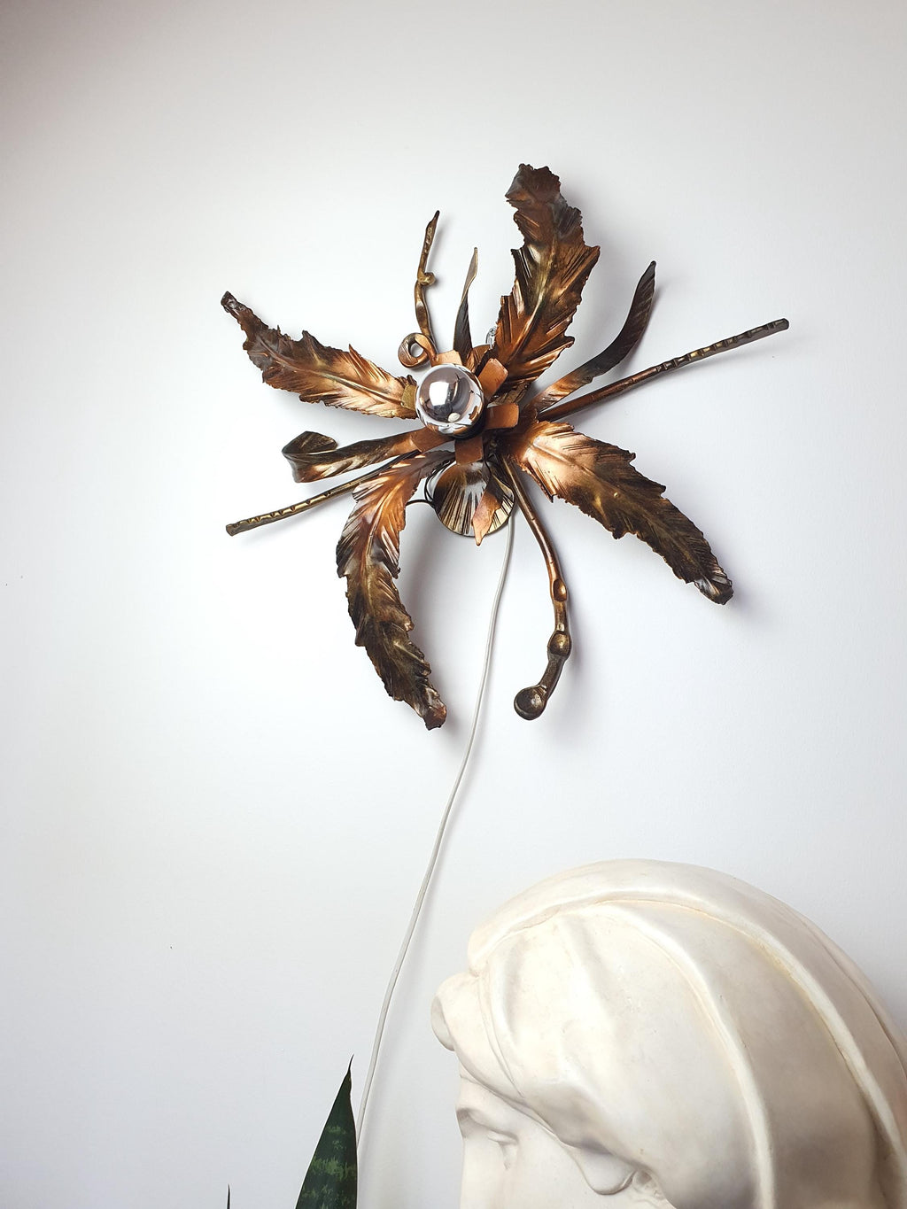 Organic curves and layered leaves on a vintage 1980s metal light
