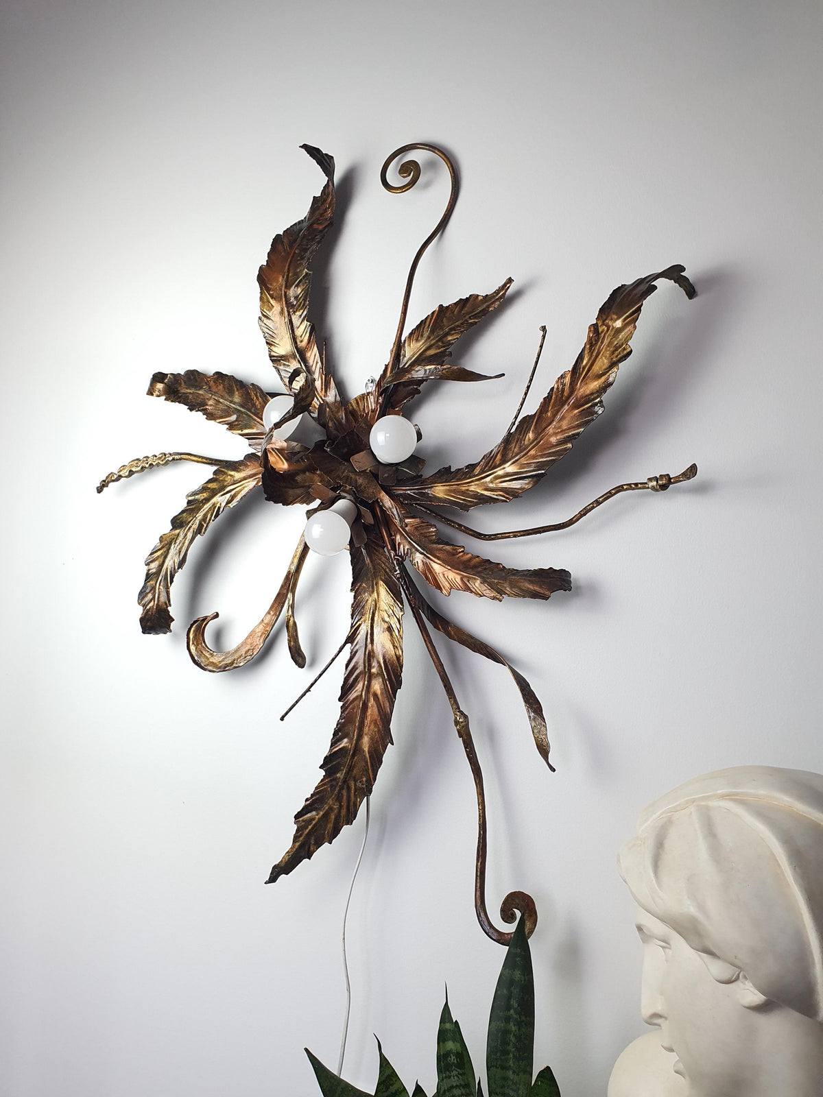 Oversized handcrafted metal light with sculptural leaves and branches
