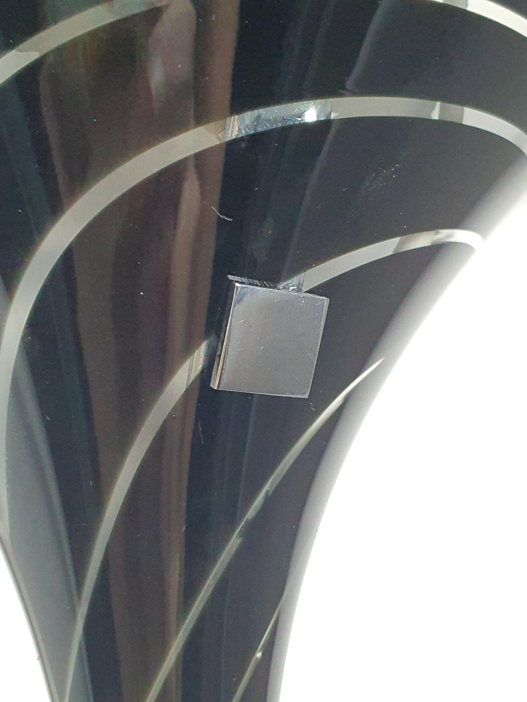 Close-up of black and clear zebra stripe layered art glass on vintage Murano calla lily wall sconce, dynamic stripe pattern