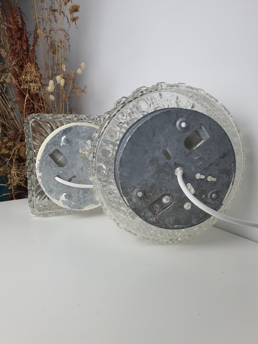 Circular glass shade with bold raised texture and geometric form
