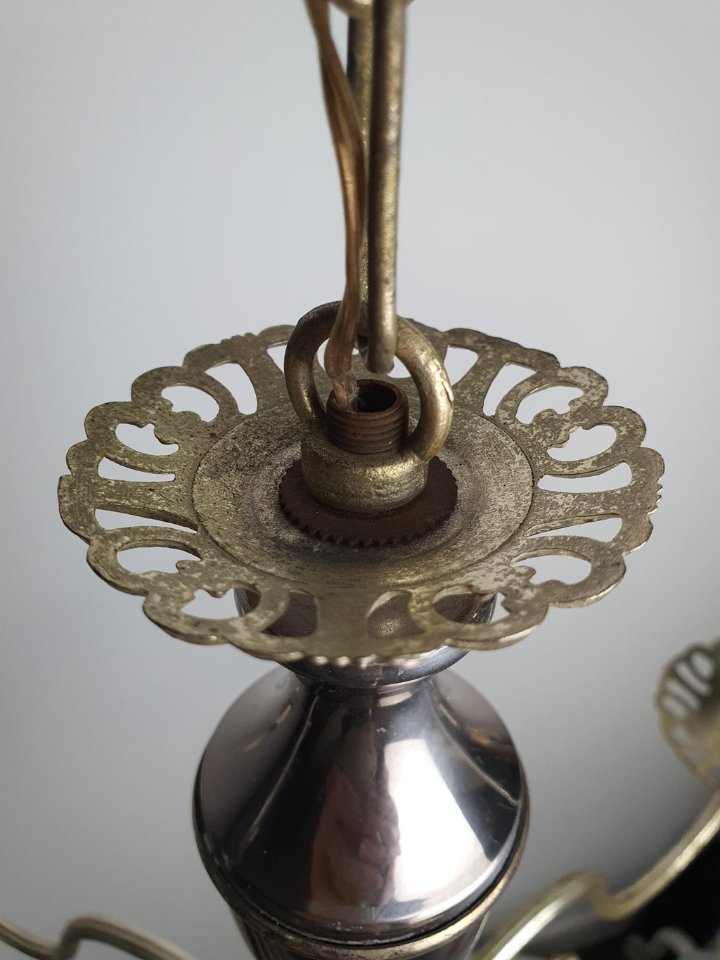 Close-up of silver-tone patina on vintage Italian 3-arm candle chandelier arm and socket detail