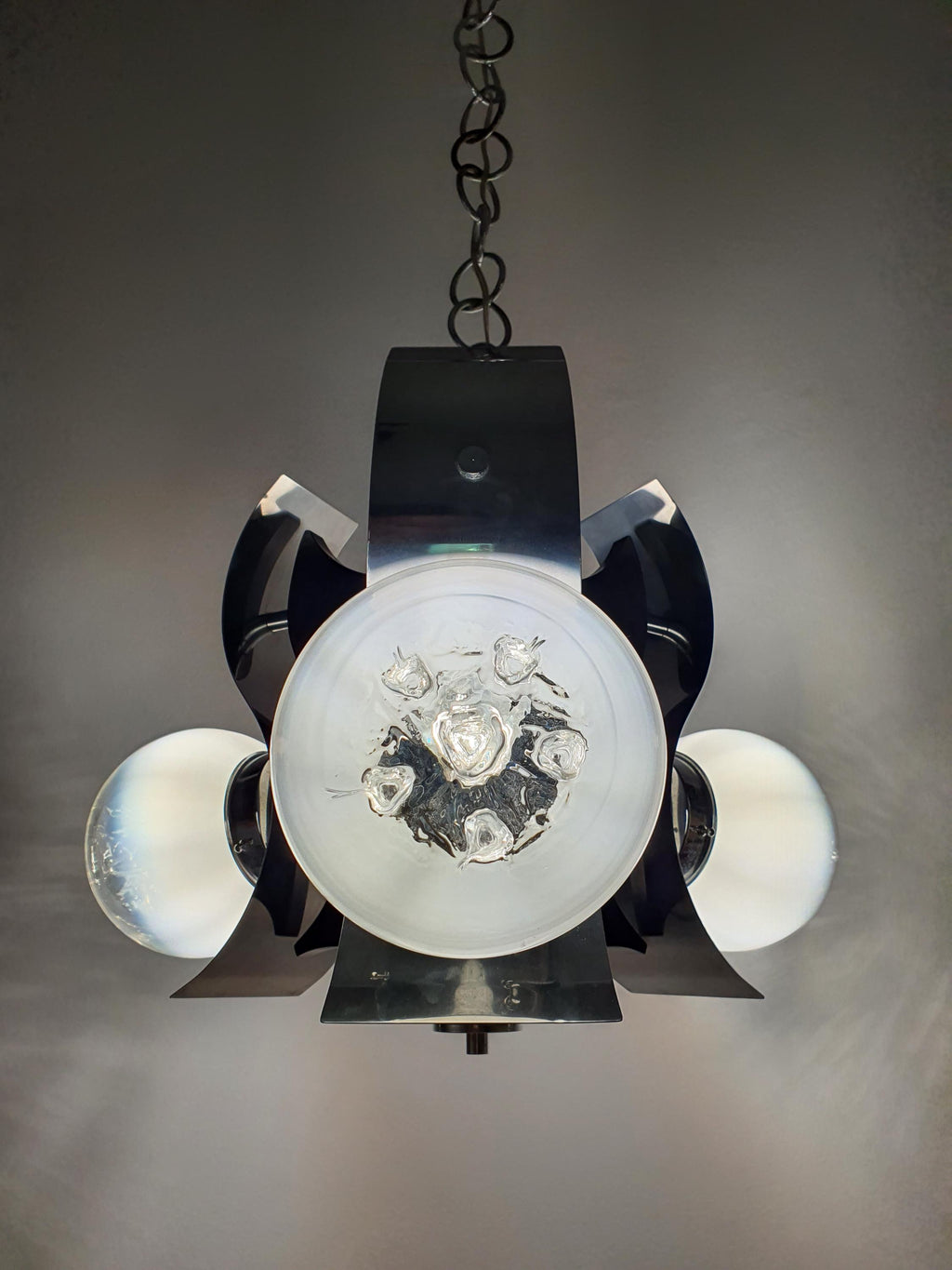 Mazzega-style Murano chandelier side profile, three globes on chrome arms, wooden base detail, 1970s MCM