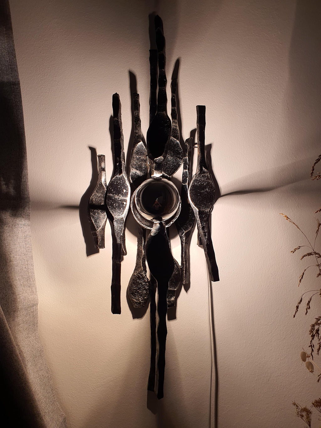 Vintage Belgian wall sconce unlit, showing sculptural iron composition and geometric form